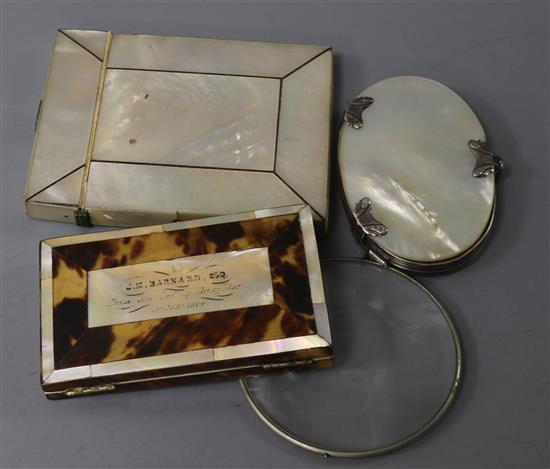 A 19th century tortoiseshell and ivory card case, two mother of pearl card cases and a silver magnifying glass